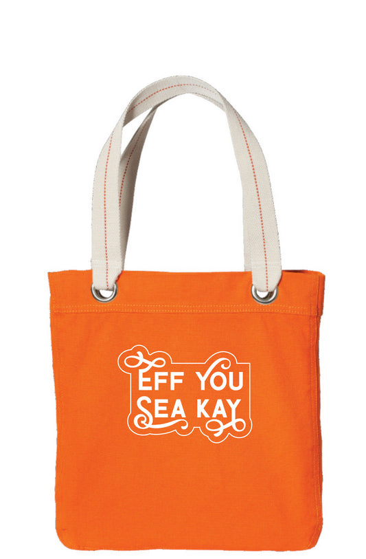 Image of tote in bright orange with silver-toned grommets and a woven canvas strap with a dotted red line through the center. The front of the bag as "Eff You Sea Kay" in a decorative font with 4 letters having swashes and an outline of the shape.